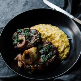 veal osso bucco recipe with gremolata and creamy polenta in a bowl