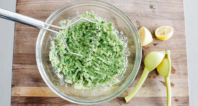 mashing avocados in a bowl