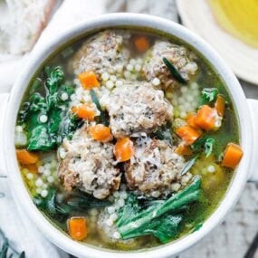 a bowl of italian soup with meatballs and vegetables