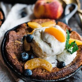 peach cobbler with blueberries and ice cream