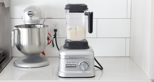 mixing a waffle cone batter in a blender