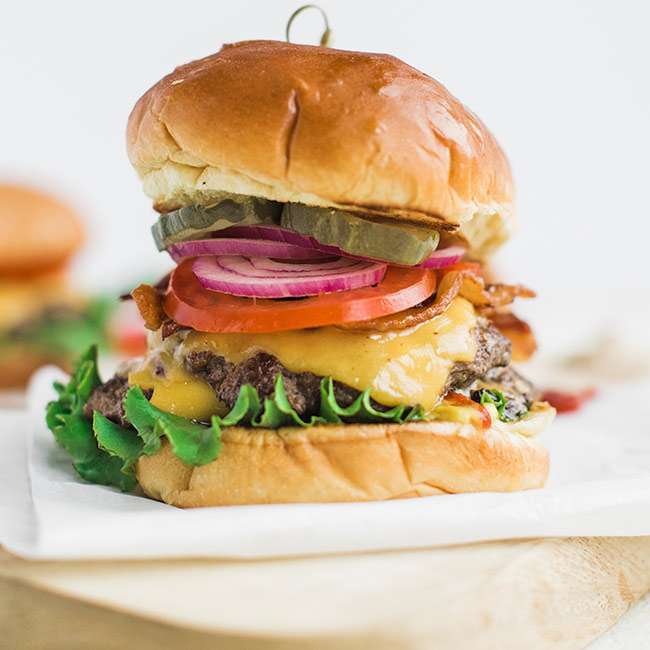 Classic Cheeseburger Recipe on Brioche with Lettuce Tomato and Onions ...