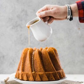 pouring caramel on a bundt cake