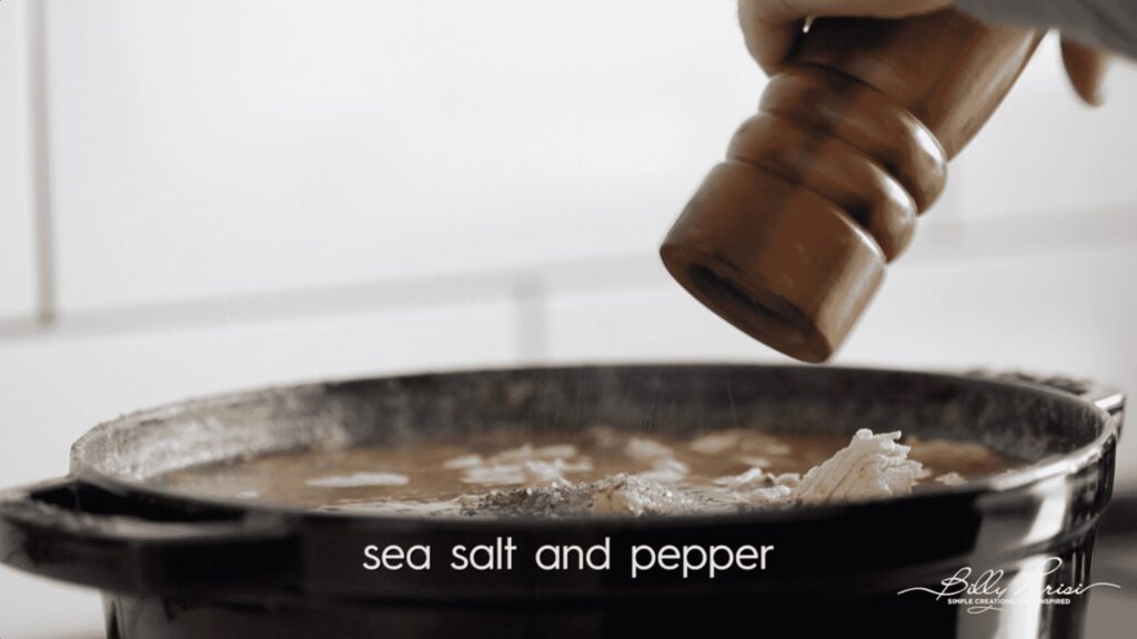 adjusting the seasonings of a soup with salt and pepper