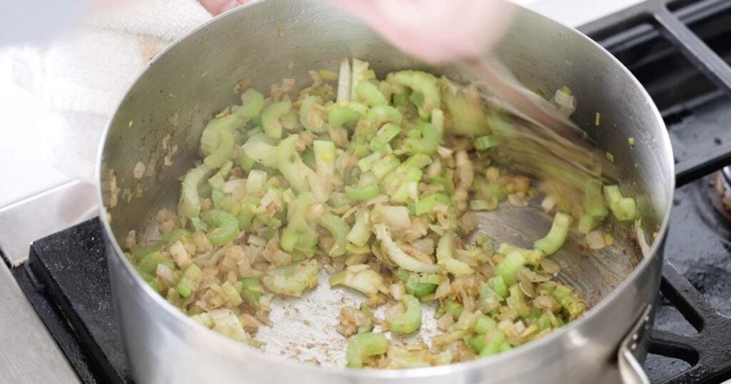 adding celery to cooked onions