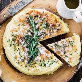 sliced frittata with olive oil, parmesan cheese and fresh herbs