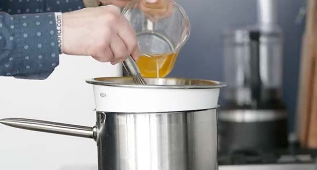 whisking butter into a bowl