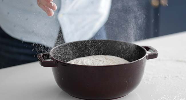 adding dough to a dutch oven