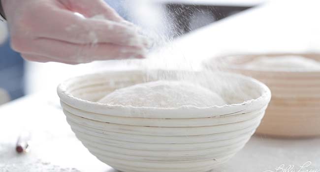 flouring dough in a basket