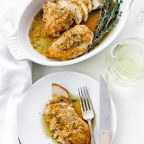 casserole dish of sliced chicken with a plate of sliced chicken