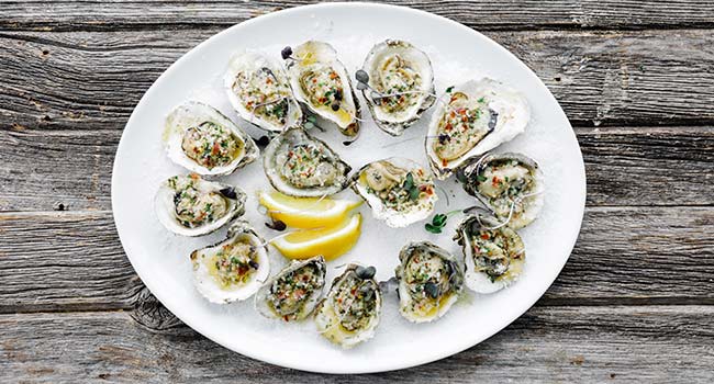 beer butter grilled oysters on a platter