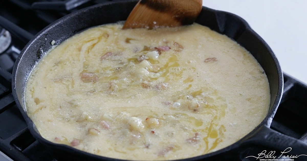 adding eggs to a skillet