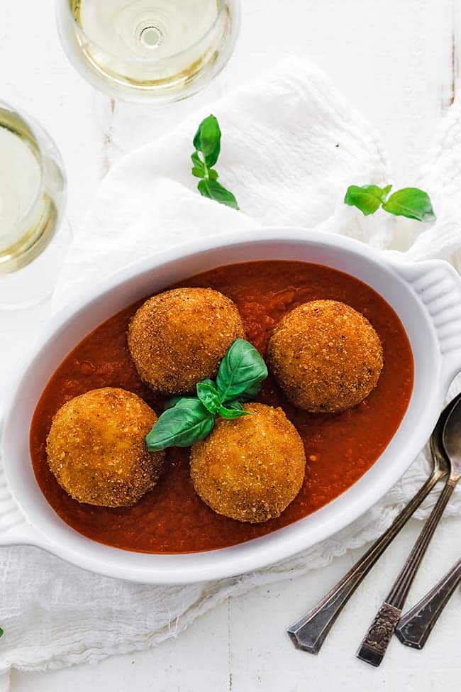 white wine served with arancini balls and pomodoro sauce