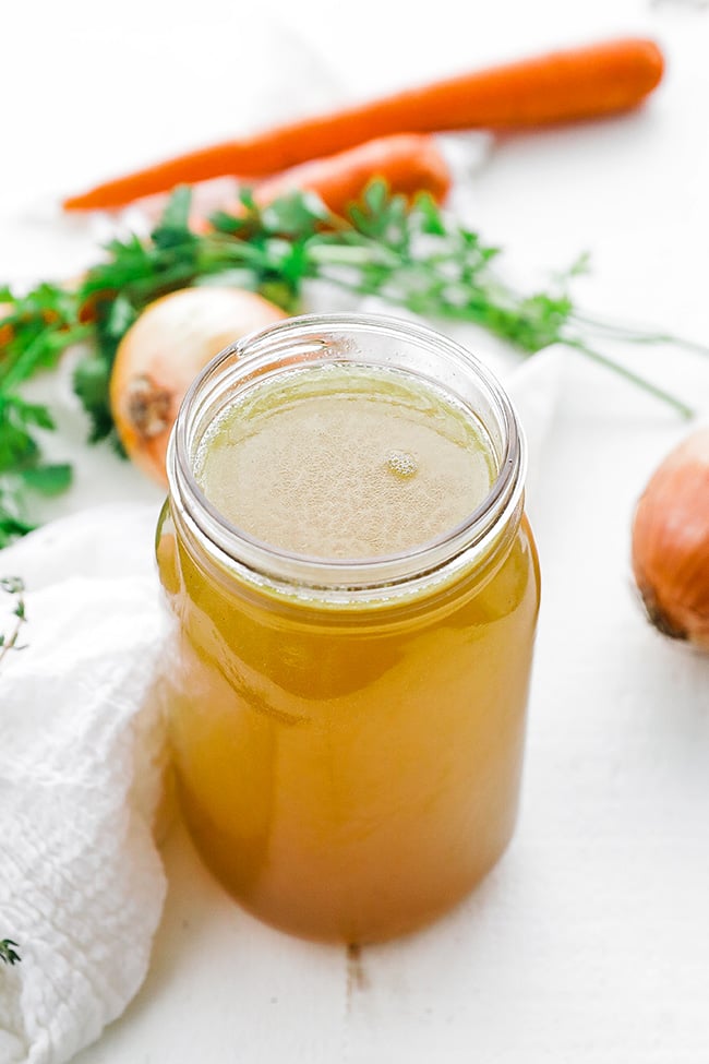 chicken stock in a jar with vegetables