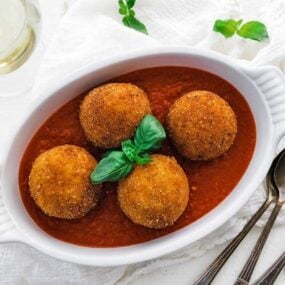 white wine served with arancini balls and pomodoro sauce