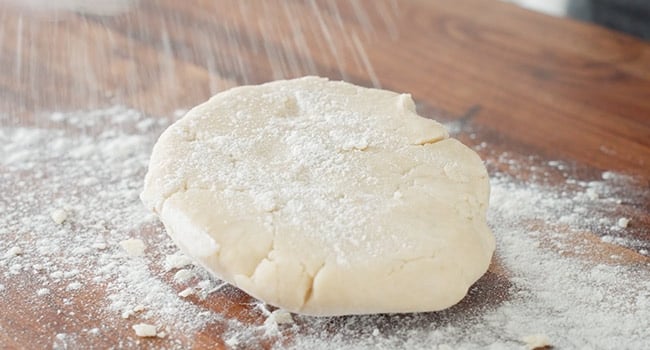 sprinkling flour on dough