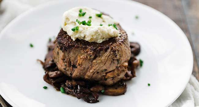 blue cheese butter on a steak with mushrooms