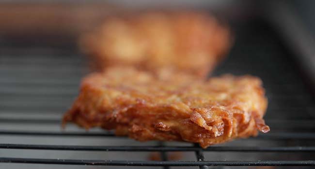 draining a latke on a rack