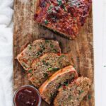 meatloaf on a cutting board with glaze