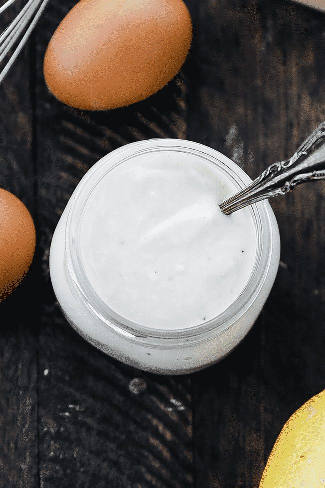 glass of caesar dressing with a spoon