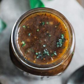 balsamic vinaigrette recipe in a jar with fresh chopped basil