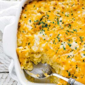 macaroni and cheese casserole dish with a large spoonful taken out