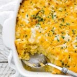 macaroni and cheese casserole dish with a large spoonful taken out