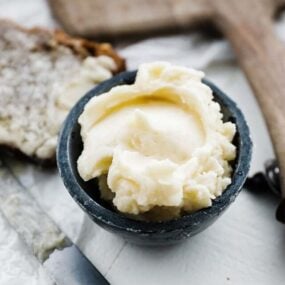 bowl of honey butter with slice of bread