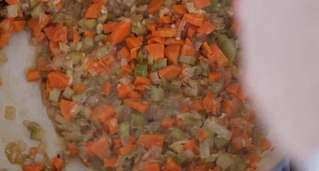 deglazing with white wine in a pot with vegetables