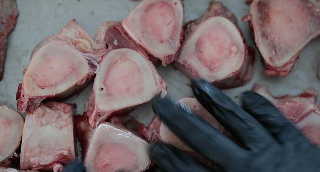 coating beef bones in oil in a pan