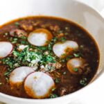 bowl of birria soup with chopped onions