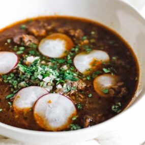 bowl of birria soup with chopped onions