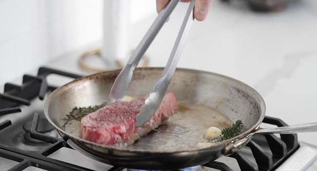 moving a steak around in a hot pan