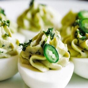 avocado deviled eggs with cilantro on a plate