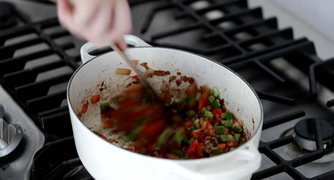 sautéing peppers in a pot 