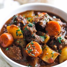 bowl of goulash served with bread