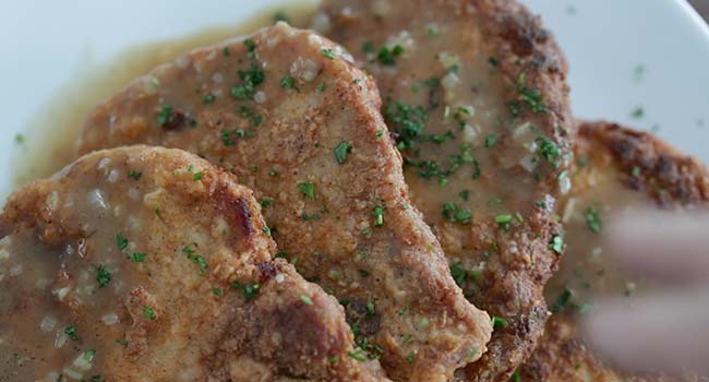 garnishing fried pork chops with parsley