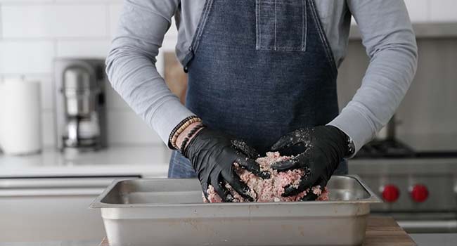 mixing together sausage in a pan