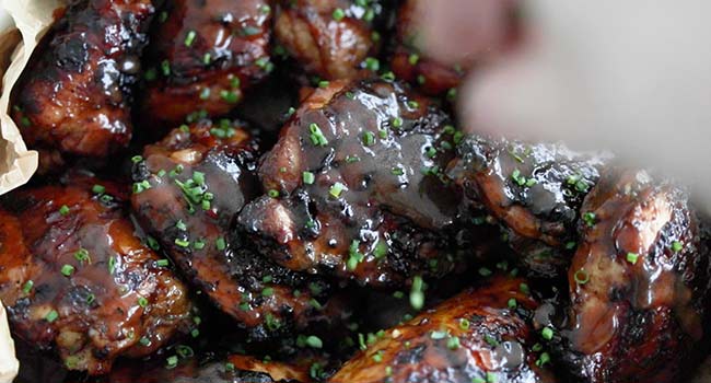 garnishing grilled chicken with chives