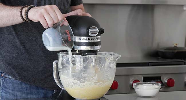 pouring milk into a stand mixer