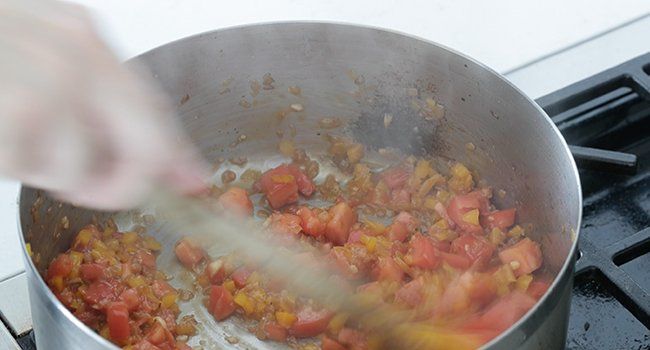 cooking tomatoes with onion and peppers