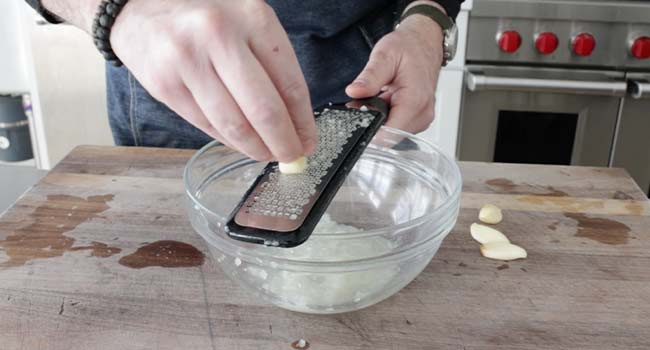 finely grating garlic