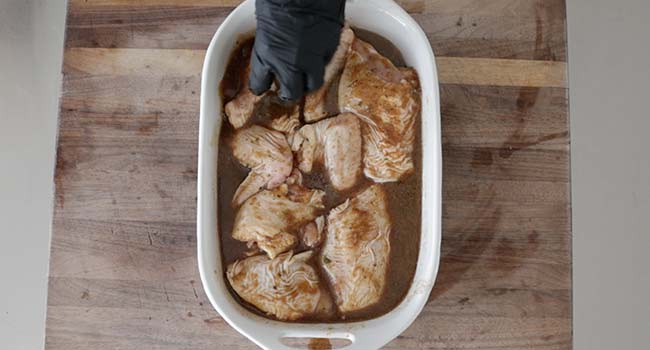 mixing chicken with a marinade