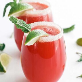 watermelon agua fresca in a glass with a sugar rim