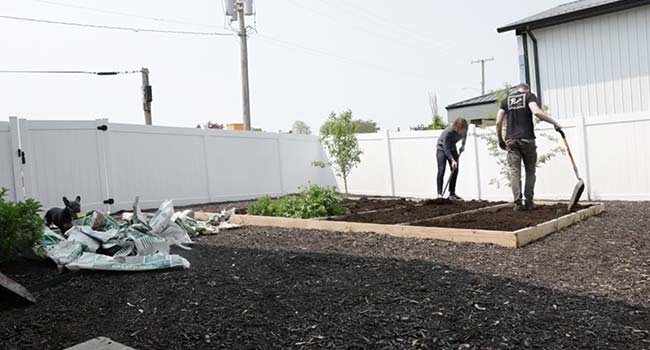 adding soil to compost