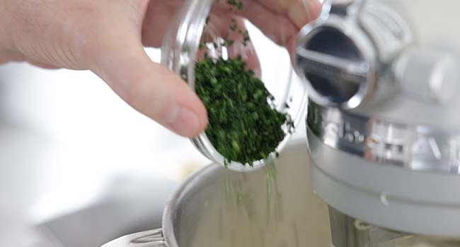 adding parsley to whipped butter