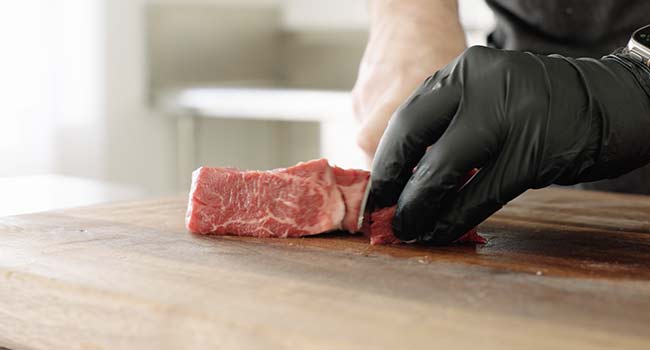 cutting beef into cubes