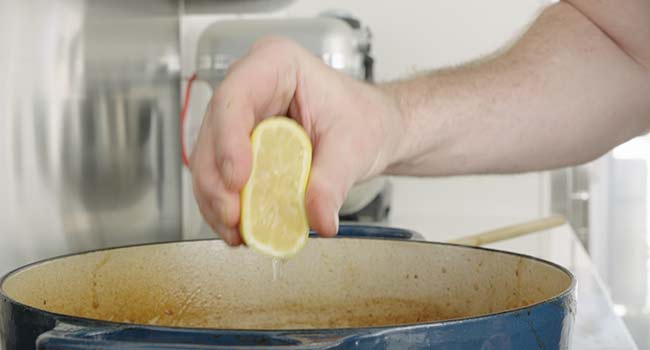 adding lemon juice to a stew