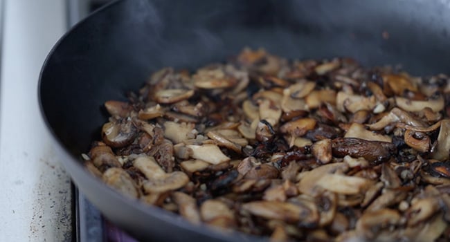 mixing herbs with mushrooms