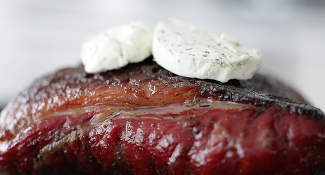 adding butter to a picanha